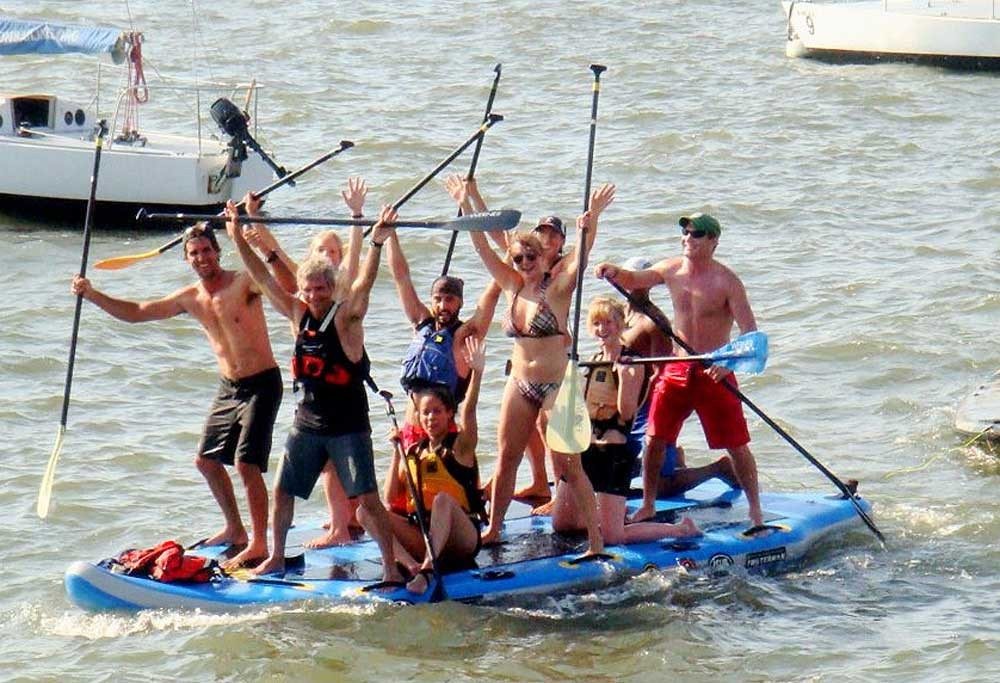 a group of people in a small boat in a body of water