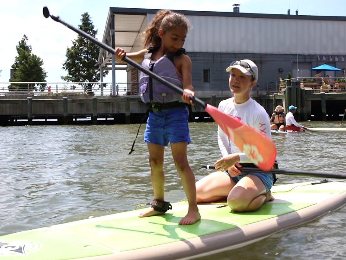 a person riding on the back of a boat in the water