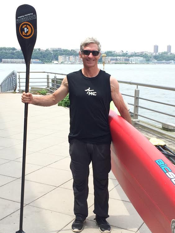 George Stanley standing next to a body of water posing for the camera