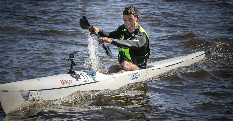 a person riding a surf board on a body of water