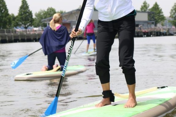 a person riding a surf board on a body of water