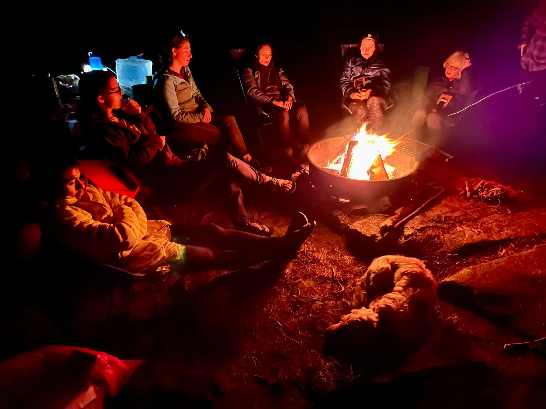 Campfire-with-Manhattan-Kayak a group of people sitting around a fire