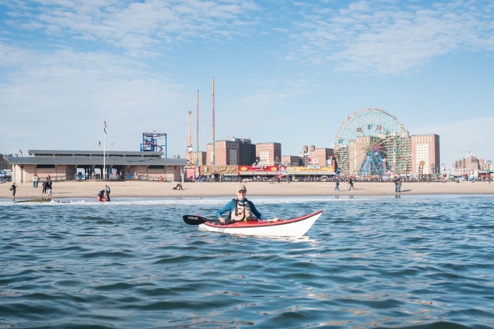 a group of people in a boat on a body of water