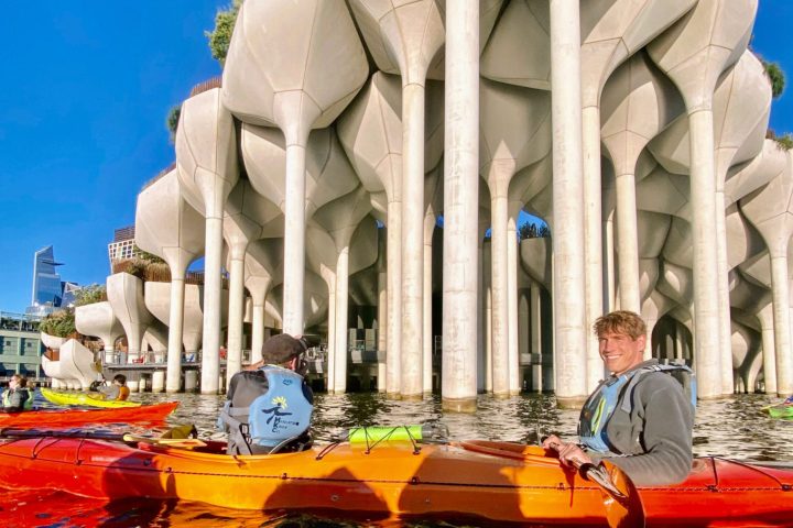 two men riding a tandem kayak on the Hudson River at Little Island