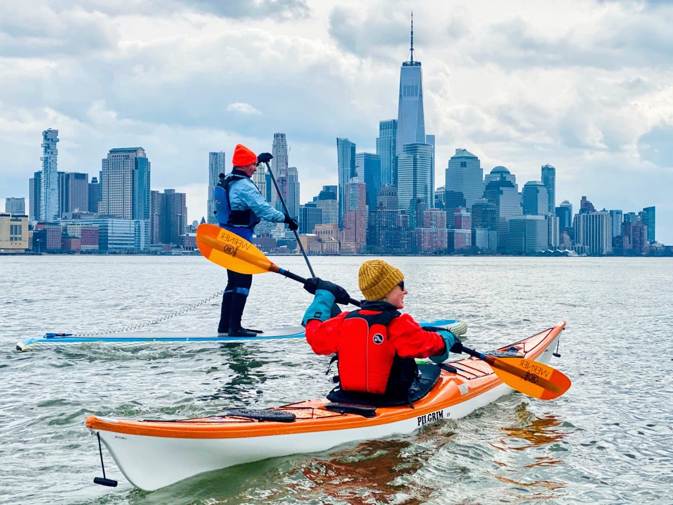 a man riding on the back of a boat in the water