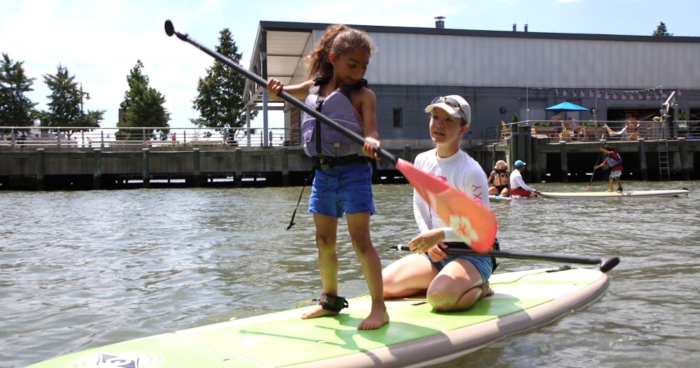 a person riding on the back of a boat in the water