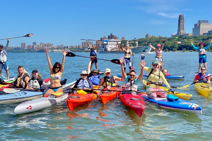 people on kayaks and paddleboards on the Hudson River