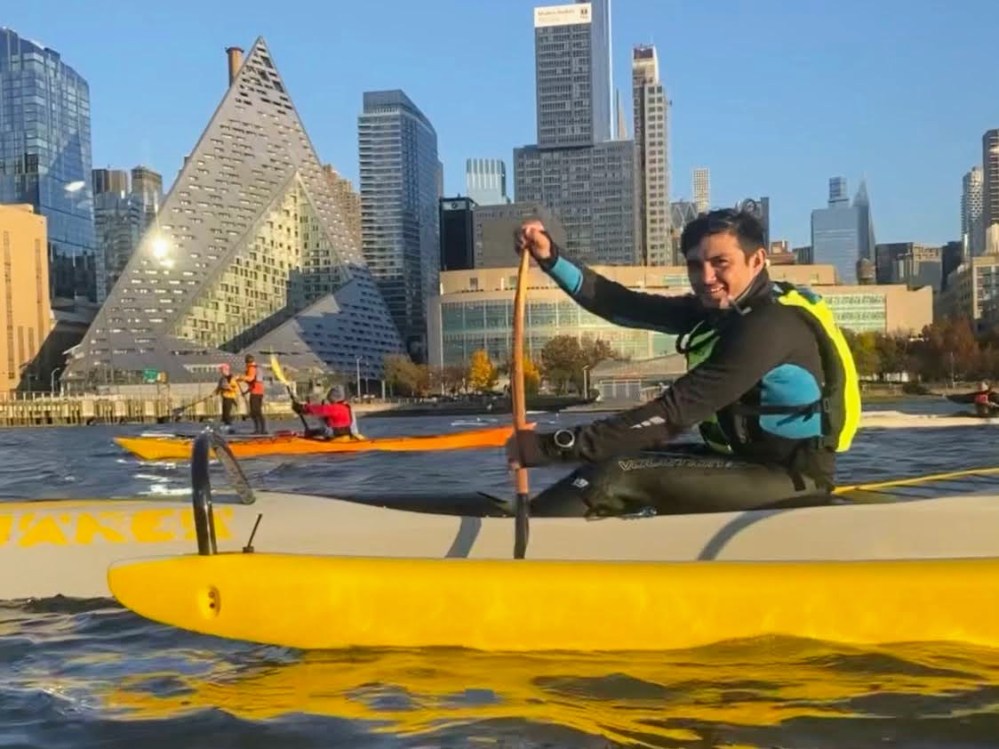 a man on an outrigger canoe