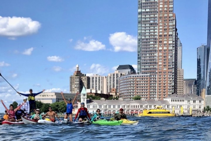 a group of people on a boat in a large body of water