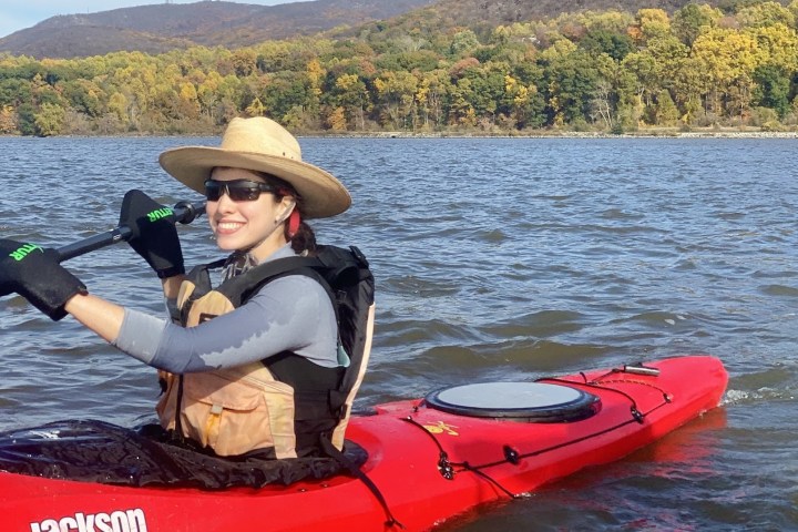 a person riding on the back of a boat in a body of water