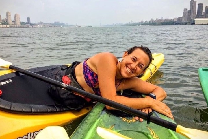 a person sitting next to a body of water