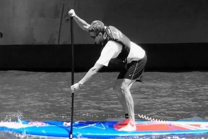 a person riding a paddle board in the water