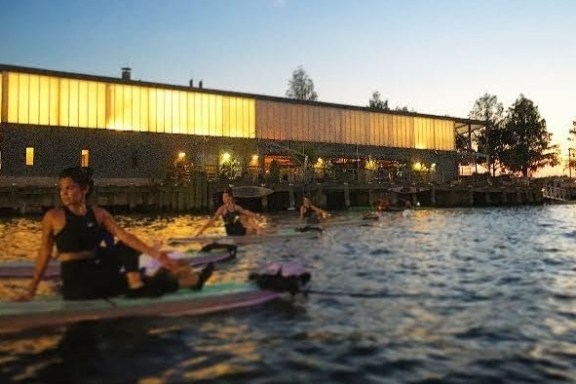 a man riding on the back of a boat in the water