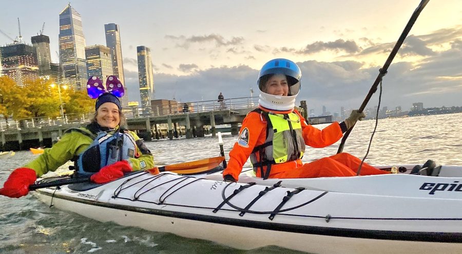 Kayakers during Halloween in costumes in front of Hudson Yards.