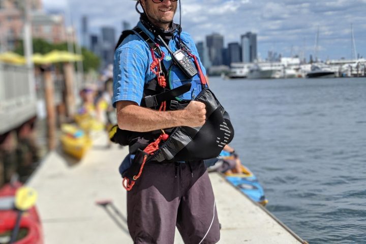 a kayak guide standing on the dock at Surf City