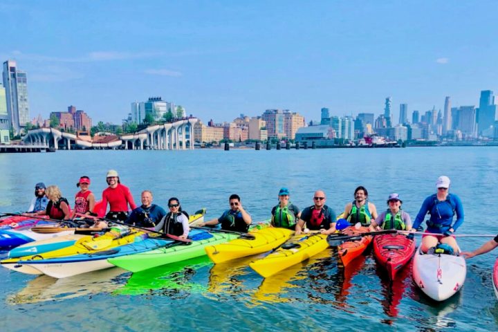 a group of people riding on kayaks in the water