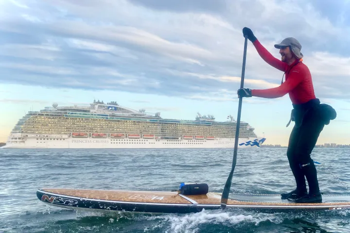a person riding a wave on a surfboard in the water