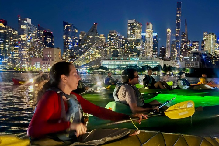 people kayaking in the dark at night in NYC