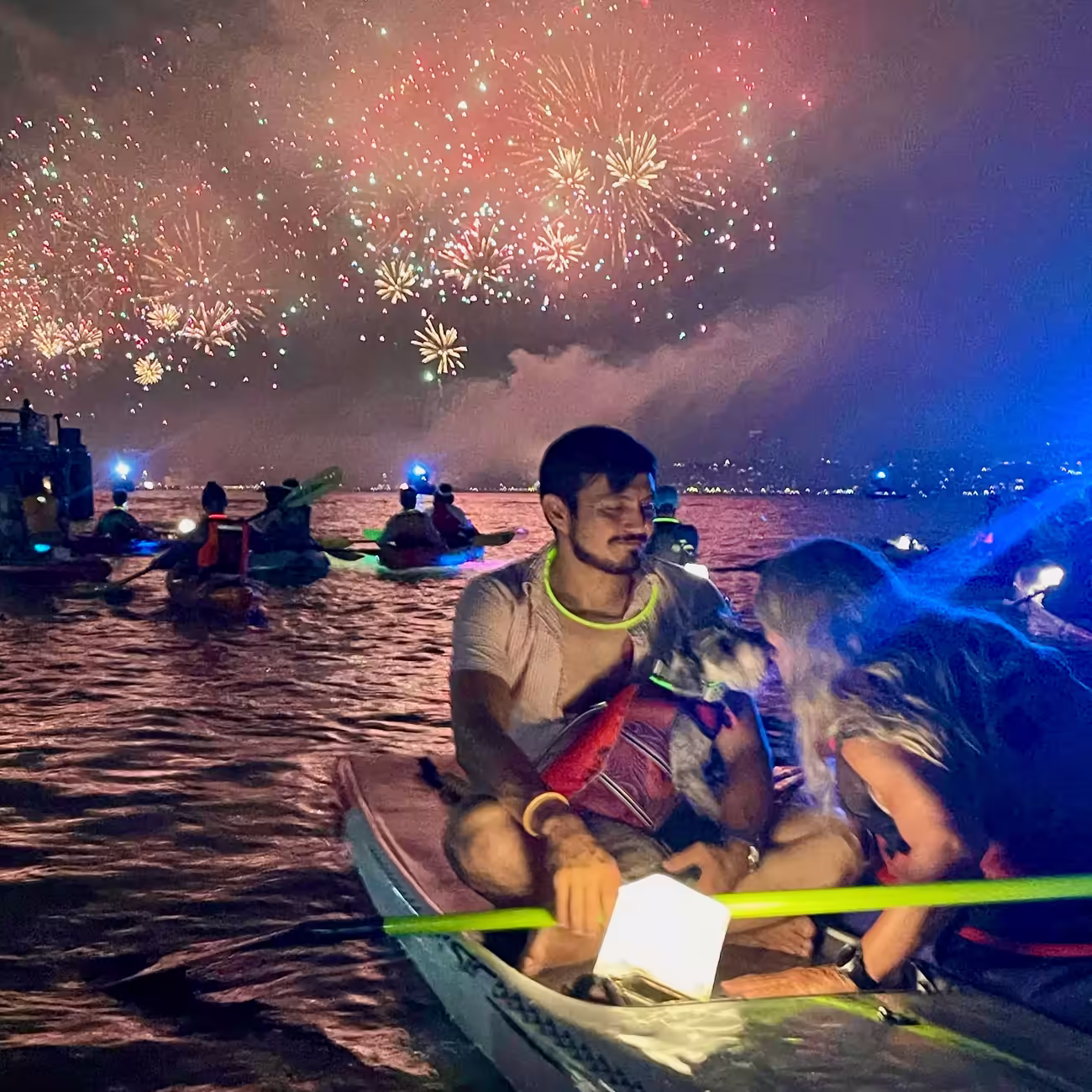 Manhattan Kayak Co members floating on the water during July 4th fireworks in NYC.
