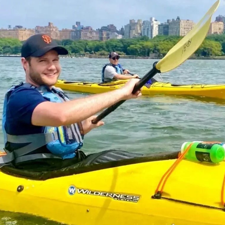 Two students in yellow Wilderness Systems sea kayaks practice navigating the open Hudson River during a Kayak Basics 3 class, with the Upper West Side skyline in the background.