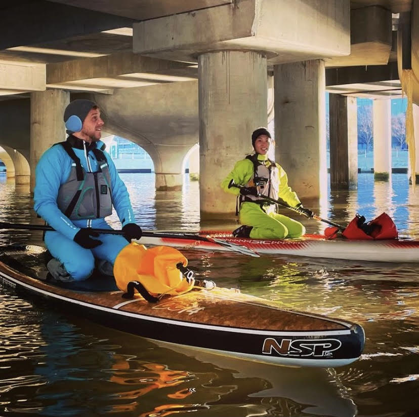 Two people kneeling on paddleboards at Little Island in NYC. Photo by @161st_and_river