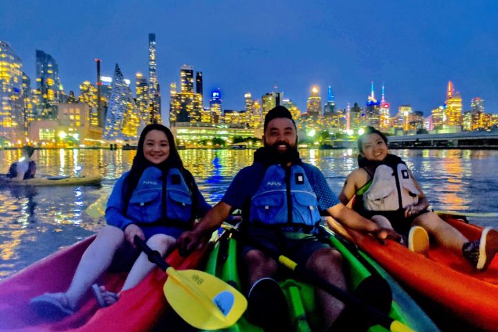 a group of people sitting in a boat on a body of water