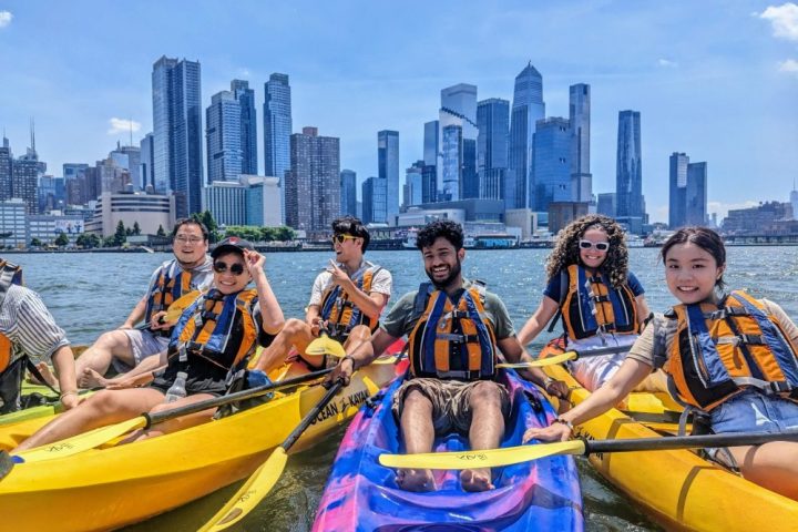 A group of people riding sit-on-top kayaks during Manhattan Kayak's Skyline Kayaking Trip in NYC.