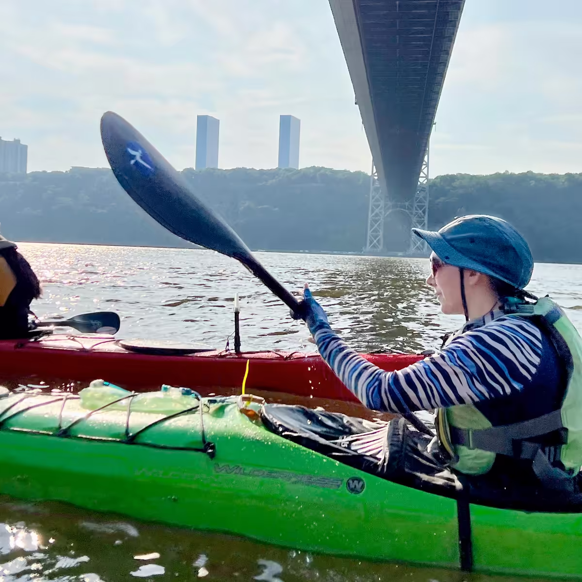 Kayakers moving swiftly underneath the George Washington Bridge.