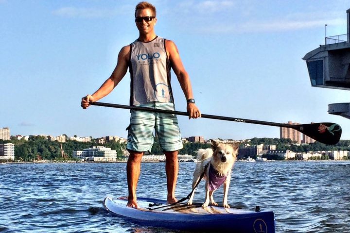 a man and a dog on a boat in the water