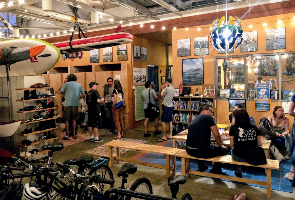 a group of people sitting and standing in front of a store