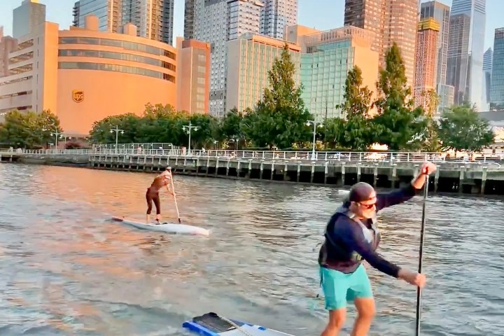 a group of people riding skis on a body of water