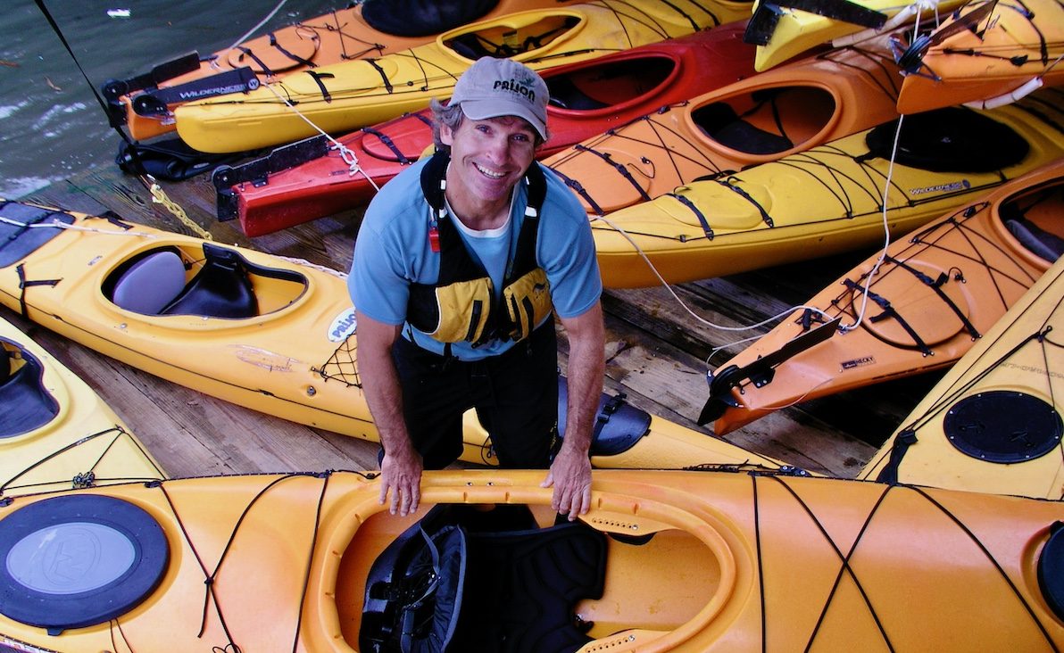 Eric Stiller a kayak instructor holding a sea kayak