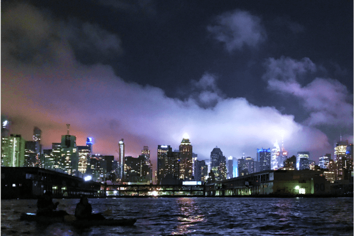 Manhattan after dark on the Hudson River at night kayaking during NYC kayaking group