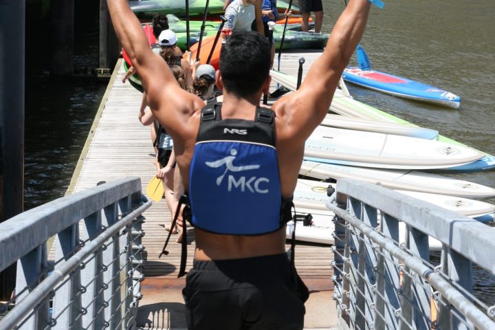 a person walking across a bridge over water