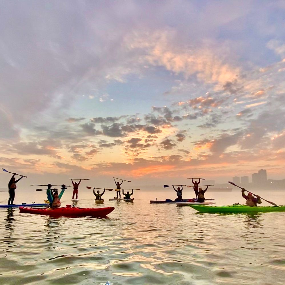 a group of people in a boat on a body of water