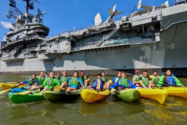 a group of people kayaking in NYC