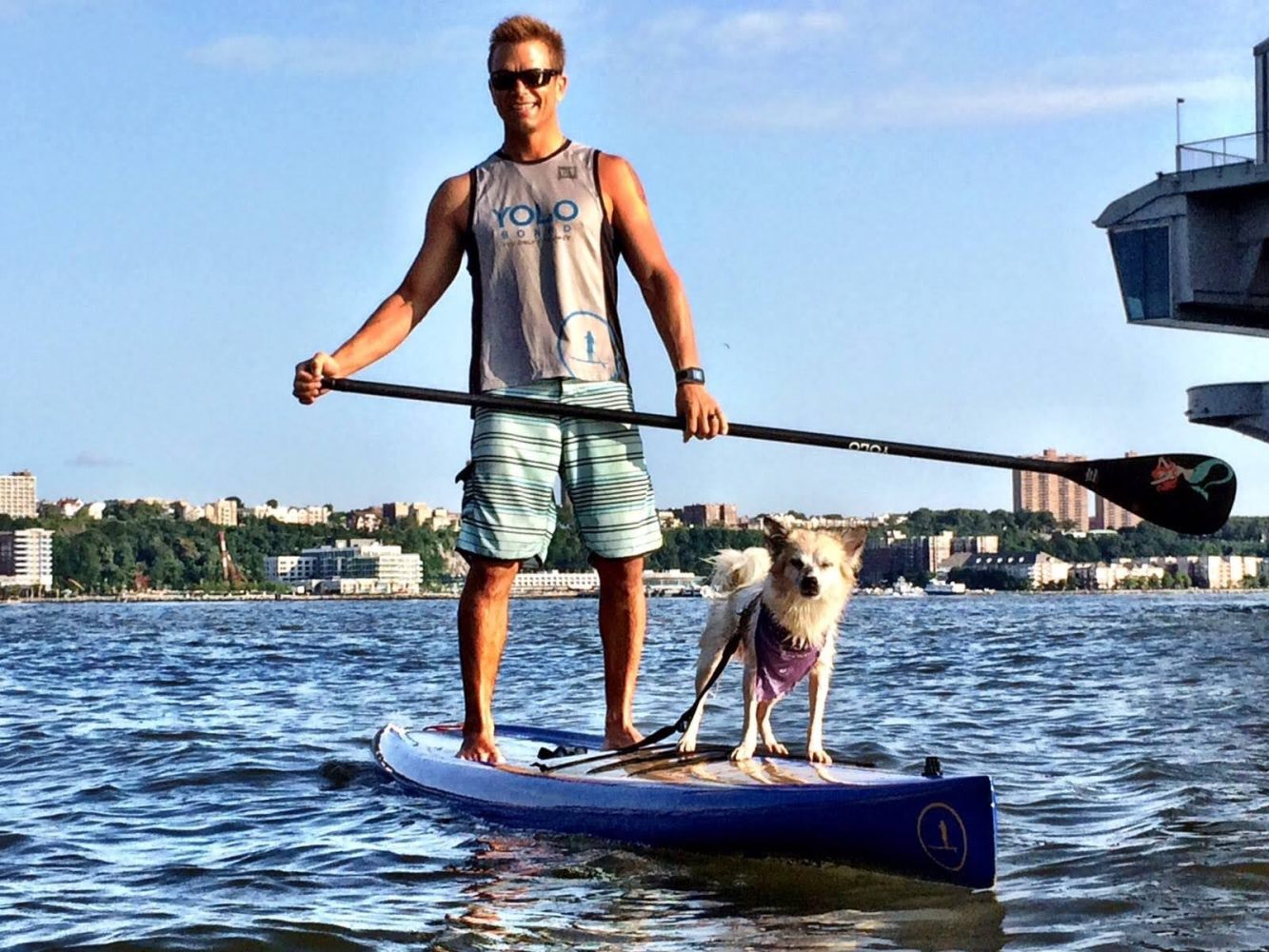 a man and a dog on a SUP