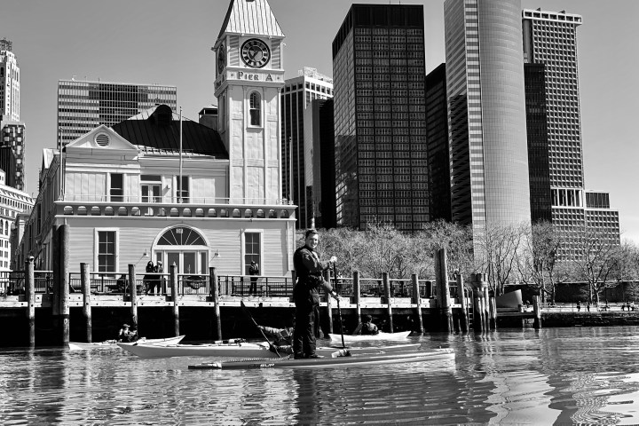 a large body of water with a city in the background