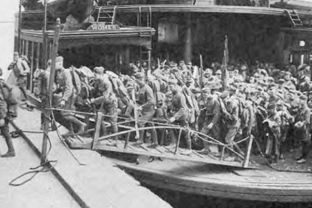 an old photo of a group of people standing in front of a building
