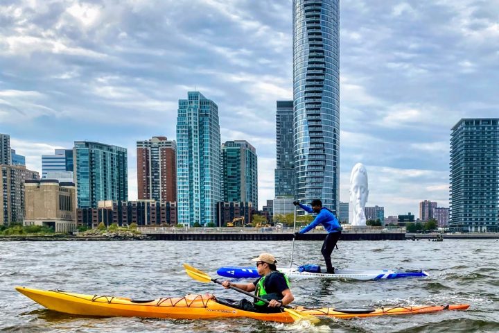 a kayaker and a paddle boarder in Jersey City