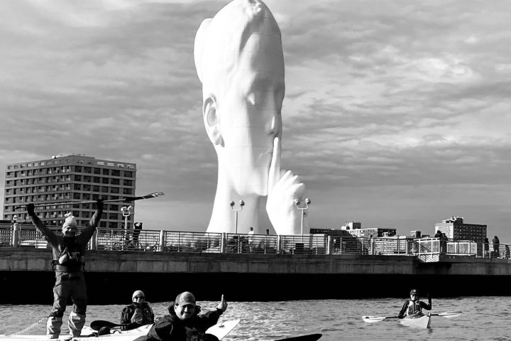 a group of people in a boat on a body of water
