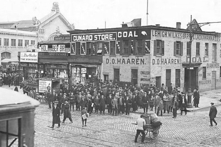 a vintage photo of a horse drawn carriage on a city street