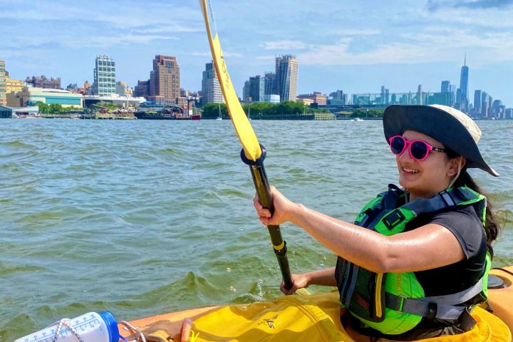 a woman in a sea kayak on the Hudson River