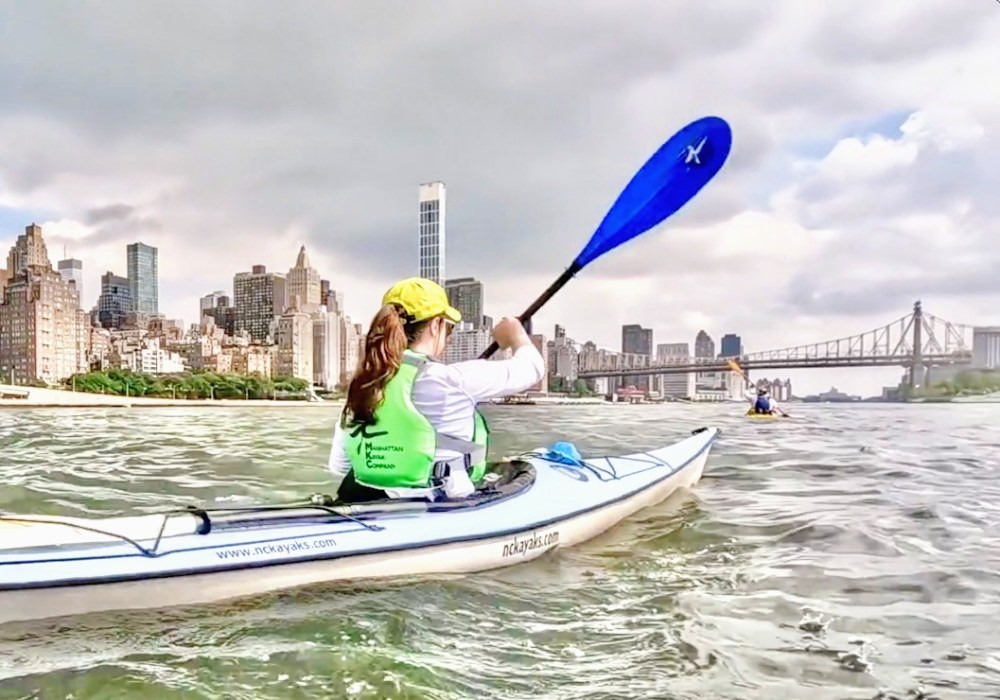 a person riding on the back of a boat in the water