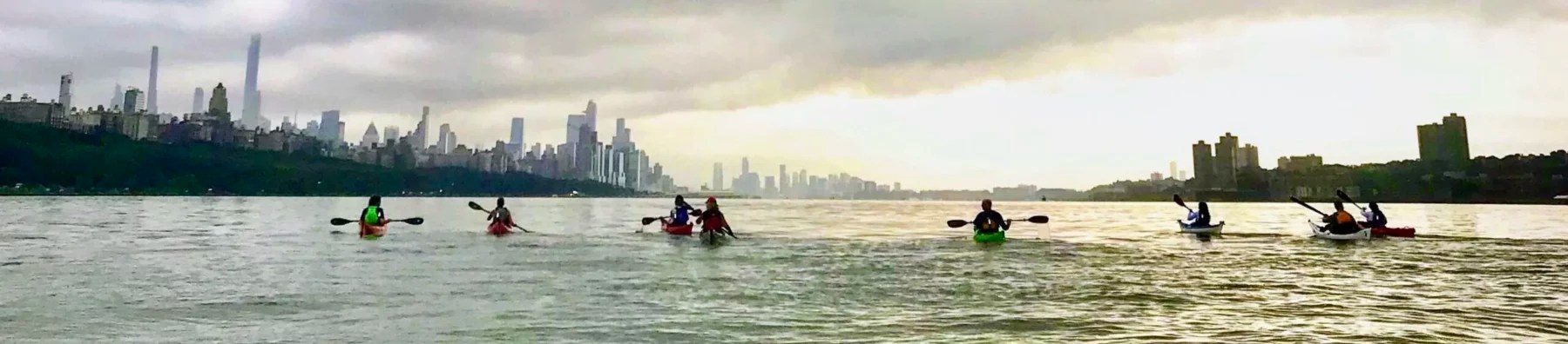 a group of people kayaking on the Hudson River near NYC