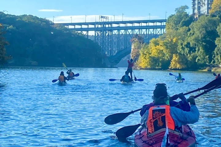 a group of people in a small boat in a body of water