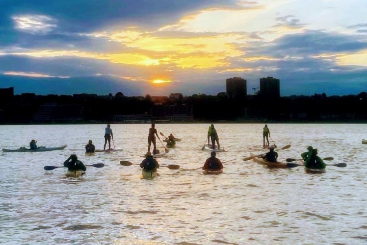 a group of people on a boat in a body of water