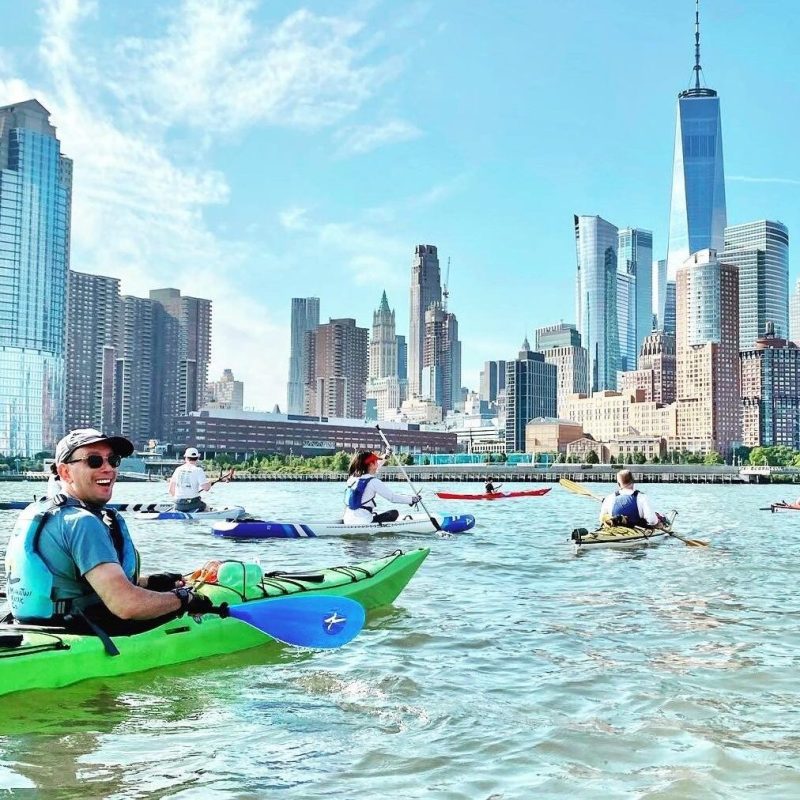 a group of people rowing a boat in the water