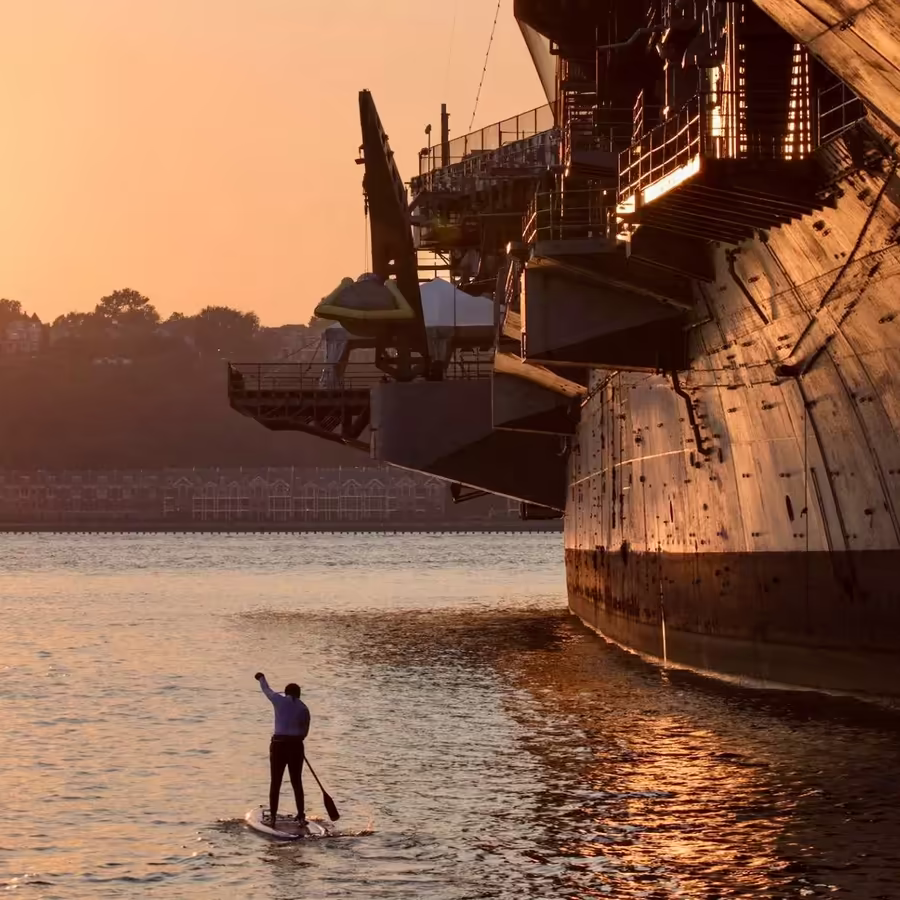 Paddler at sunset on the Hudson River, a cool alternative to crowded NYC beaches and pools during a heatwave.