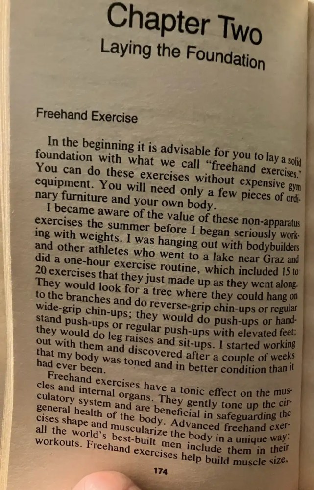 Someone holding an open book to Chapter Two, discussing freehand exercises.